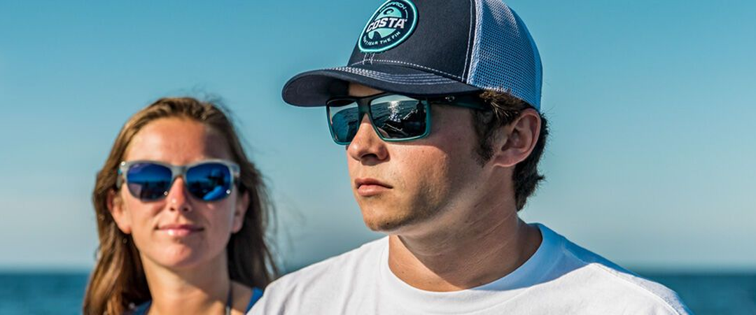 Man and woman wearing Costa sunglasses