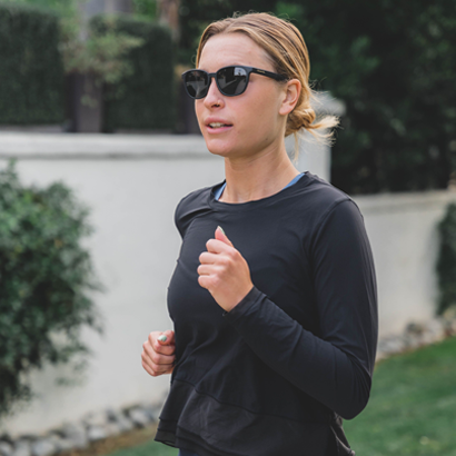 Woman running wearing SportRx sunglasses