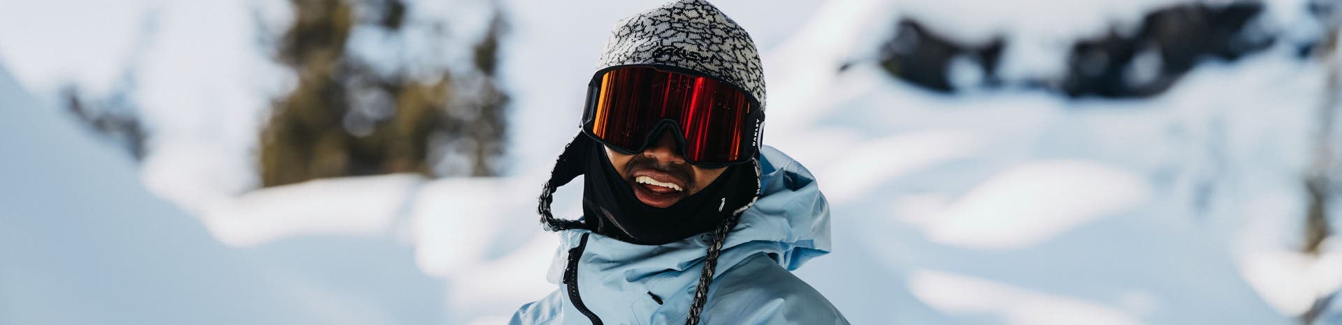 A man in Oakley prescription ski goggles smiles in his snow gear.