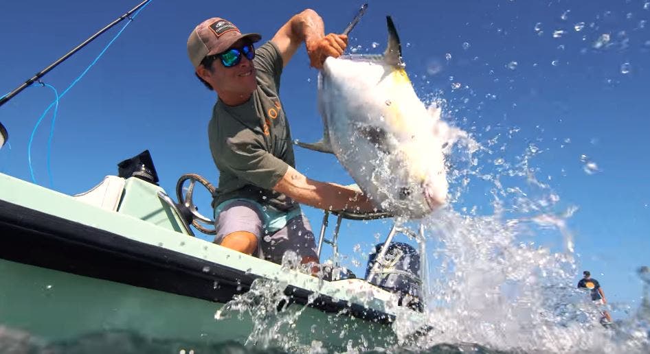 Men wearing polarized sunglasses catching a fish