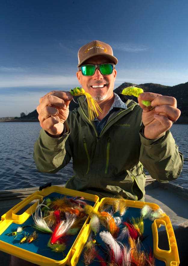 SPY Fishing sunglasses on male angler on boat with bait. 