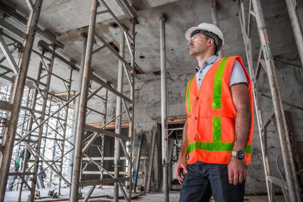 Man wearing safety glasses on construction site.