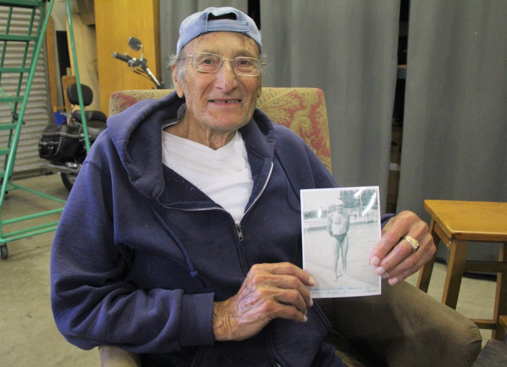 Agostino Holding a Photo of Himself