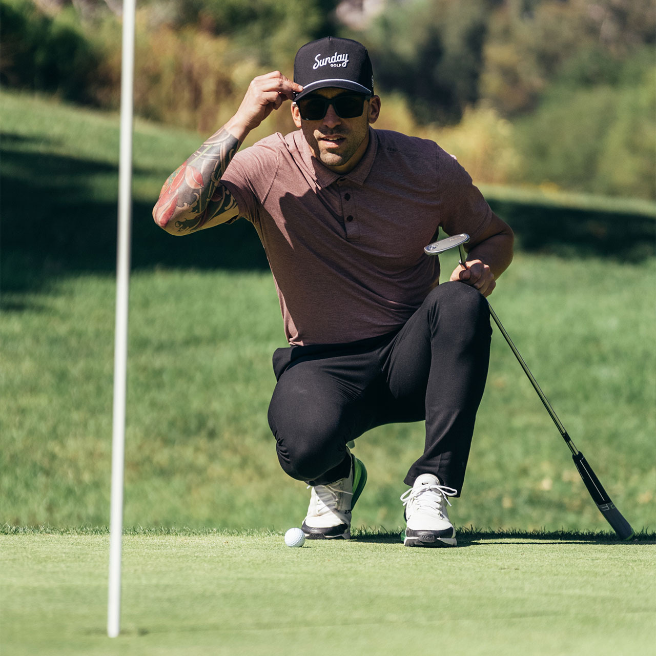 man trying to read the green to find out, are polarized golf sunglasses better for golf