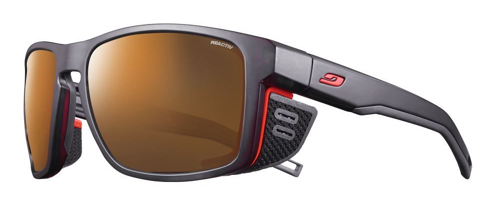 Julbo Shield sunglasses in black and orange with brown lenses.